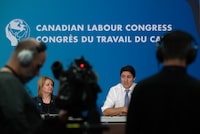 Canadian Labour Congress President Bea Bruske looks on as Prime Minister Justin Trudeau delivers remarks at a meeting in Ottawa, Thursday, April 18, 2024. THE CANADIAN PRESS/Adrian Wyld