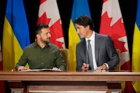 Ukrainian President Volodymyr Zelenskyy, left, and Prime Minister Justin Trudeau sign a free trade agreement ahead of a joint press conference on Parliament Hill in Ottawa on Friday, Sept. 22, 2023. THE CANADIAN PRESS/Adrian Wyld