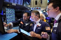 Traders work on the floor at the New York Stock Exchange (NYSE) on Jan. 29.