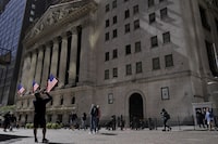 A visitor take a photo of the New York Stock Exchange, Friday, Sept. 23, 2022, in New York.