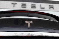 FILE - The company logo shines off the rear deck of an unsold 2020 Model X at a Tesla dealership in Littleton, Colo, on April 26, 2020. A conglomerate of unions in Norway on Wednesday Dec. 6, 2023 said it will take action against Tesla in solidarity with their Swedish colleagues who are demanding that the Texas-based automaker sign a collective bargaining agreement. (AP Photo/David Zalubowski, File)