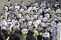 Unionized medical workers stage a rally demanding trainee doctors to return to work in front of Severance Hospital in Seoul, South Korea, Monday, April 1 2024, The signs read, "To promote social dialogue to normalize medical treatment and stop refusing treatment." South Korea's President Yoon Suk Yeol vowed Monday not to back down in the face of vehement protests by doctors seeking to derail his plan to drastically increase medical school admissions, as he called their walkouts "an illegal collective action" that poses "a grave threat to our society."(Kim Sung-min/Yonhap via AP)