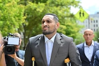Australian tennis player Nick Kyrgios arrives on crutches to the magistrate's court in Canberra on February 3, 2023. - Kyrgios will try to have an assault charge against him dismissed on mental health grounds. (Photo by SAEED KHAN / AFP) (Photo by SAEED KHAN/AFP via Getty Images)