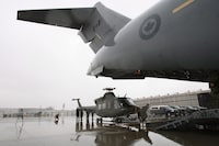 A CH-146 Griffon helicopter from Canadian Forces Base Bagotville, is being loaded onto a C-17 Globemaster airplane, at Canadian Forces Base Trenton in Trenton, Ont., on Sunday Nov. 17, 2013. Four Canadian Griffon helicopters will be sent to Latvia next year as part of a NATO deterrence mission.THE CANADIAN PRESS/Lars Hagberg