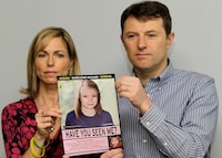 FILE - Kate and Gerry McCann pose for the media with a missing poster depicting an age progression computer generated image of their still missing daughter Madeleine during a news conference in London, May 2, 2012. Portuguese police say they'll resume searching for Madeleine McCann, the British toddler who disappeared in the country’s Algarve region in 2007, in the next few days.Portugal's Judicial Police released a statement confirming local media reports that they would conduct the search at the request of the German authorities and in the presence of British officials. (AP Photo/Sang Tan, File)