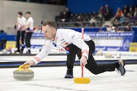 Canada's Brad Gushue releases the rock during a match against Sweden at the men's curling world championship at the IWC Arena in Schaffhausen, Switzerland, Thursday, April 4, 2024. (Ennio Leanza/Keystone via AP)