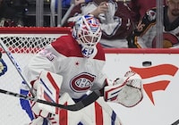 Montreal Canadiens goaltender Sam Montembeault deflects puck in the second period of an NHL hockey game against the Colorado Avalanche Tuesday, March 26, 2024, in Denver. (AP Photo/David Zalubowski)