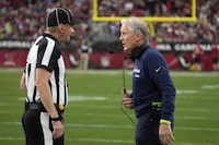 Seattle Seahawks head coach Pete Carroll talks with an official in the first half of an NFL football game between the Seahawks and the Arizona Cardinals Sunday, Jan. 7, 2024, in Glendale, Ariz. (AP Photo/Rick Scuteri)