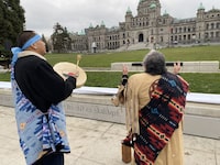 Elder Mary Ann Thomas and Charlie George, of the B.C. Association of Aboriginal Centres, welcome the new Indigenous signage unveiled on the grounds of the B.C. legislature, once the site of an Indigenous village, in Victoria on Wednesday Nov. 29, 2023. THE CANADIAN PRESS/Dirk Meissner 