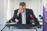 Longtime mayor of Halifax Mike Savage wipes away tears while announcing he's not running in the upcoming municipal election, during a press conference at city hall in Halifax on Tuesday, Feb. 13, 2024. THE CANADIAN PRESS/Darren Calabrese