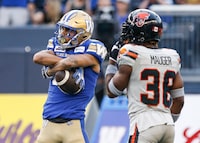 Winnipeg Blue Bombers' Kenny Lawler (89) celebrates his touchdown in front of B.C. Lions' Quincy Mauger (36) during first half CFL action in Winnipeg Thursday, August 3, 2023.    THE CANADIAN PRESS/John Woods