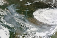 Smoke from wildfires burning in Western Canada can be seen in a Wednesday, May 17, 2023, satellite handout image. The Quebec government is sending support to Saskatchewan to help the province tackle the wildfires. THE CANADIAN PRESS/HO-NASA Worldview **MANDATORY CREDIT**