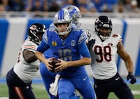 Detroit Lions quarterback Jared Goff (16) scrambles with the ball during the first half of an NFL football game against the Chicago Bears Sunday, Nov. 19, 2023, in Detroit. (AP Photo/Duane Burleson)