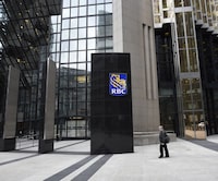 Pedestrians walk past the RBC sign outside the bank's downtown office tower in Toronto on April 7 2016.
