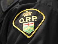 An Ontario Provincial Police logo is shown during a press conference, in Barrie, Ont., on Wednesday, April 3, 2019. THE CANADIAN PRESS/Nathan Denette