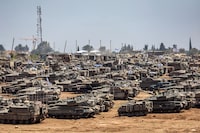 Israeli army main battle tanks and other military vehicles are positioned in southern Israel near the border with the Gaza Strip on May 9, 2024, amid the ongoing conflict in the Palestinian territory between Israel and the Hamas movement. (Photo by AHMAD GHARABLI / AFP) (Photo by AHMAD GHARABLI/AFP via Getty Images)
