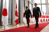Prime Minister Justin Trudeau (R) and Japanese Prime Minister Fumio Kishida walk together after a news conference on Jan. 12 in Ottawa. (Photo by Dave Chan / AFP) (Photo by DAVE CHAN/AFP via Getty Images)