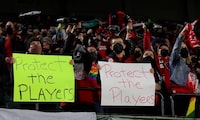 FILE - Portland Thorns fans hold signs during the first half of the team's National Women's Soccer League soccer match against the Houston Dash in Portland, Ore., Oct. 6, 2021. An investigation commissioned by the NWSL and its players union found “widespread misconduct" directed at players dating back to the beginnings nearly a decade ago of the country's top women's professional league. (AP Photo/Steve Dipaola, File)