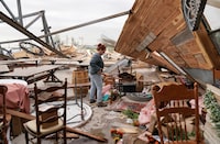 Kimber Hendrickson owner of the Scissortail Silos event centre surveys debris of her venue destroyed during overnight tornadoes in Cole, Oklahoma, U.S., April 20, 2023.  REUTERS/Nick Oxford