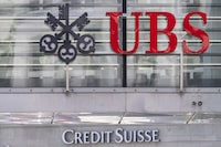The logos of the Swiss banks Credit Suisse and UBS are pictured in Zurich, Switzerland, June 12, 2023. UBS says it has completed its takeover of embattled rival Credit Suisse. The announcement comes nearly three months after the Swiss government hastily arranged a rescue deal to combine the country’s two largest banks. (Ennio Leanza/Keystone via AP)
