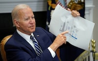 U.S. President Joe Biden holds up a wind turbine size comparison chart while attending a meeting with governors, labor leaders, and private companies launching the Federal-State Offshore Wind Implementation Partnership, at the White House in Washington, U.S., June 23, 2022. REUTERS/Kevin Lamarque