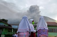 Students are seen at school as Mount Marapi volcano spews volcanic ash as seen from Nagari Batu Palano in Agam, West Sumatra province, Indonesia, December 4, 2023, in this photo taken by Antara Foto. Antara Foto/Iggoy el Fitra/via REUTERS