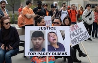 People gather and take part in a protest for Pacey Dumas, an Indigenous young man who was kicked in the head by a police officer in 2020, in Edmonton on Saturday May 6, 2023. THE CANADIAN PRESS/Jason Franson.