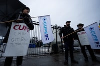 Bus and SeaBus services in Metro Vancouver are paralyzed for a second day amid a strike by transit supervisors. Transit workers from the Canadian Union of Public Employees Local 4500 picket outside of the Lonsdale SeaBus station in the rain during a strike in North Vancouver, B.C., on Monday, Jan. 22, 2024. THE CANADIAN PRESS/Ethan Cairns