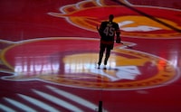 A player skates as projections of the Ottawa Senators' logo spin on the ice before an NHL game against the Boston Bruins in Ottawa, on Tuesday, Oct. 18, 2022. The Senators have signed amateur tryout defenceman Djibril Toure to a three-year, entry-level contract. THE CANADIAN PRESS/Justin Tang
