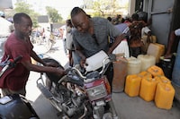 A man fills the tank of a motorcycle at a petrol station as violence spreads and armed gangs expand their control over the capital, in Port-au-Prince, Haiti March 29, 2024. REUTERS/Ralph Tedy Erol