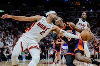 May 8, 2023; Miami, Florida, USA; Miami Heat guard Gabe Vincent (2) tips the basketball away from New York Knicks guard RJ Barrett (9) in the first quarter during game four of the 2023 NBA playoffs at Kaseya Center. Mandatory Credit: Sam Navarro-USA TODAY Sports