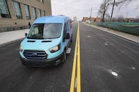 An electric van drives on a street with in-road wireless charging coils below the surface in Detroit, Wednesday, Nov. 29, 2023. A demonstration of the first electric vehicle charging road in the U.S. took place Wednesday on a quarter-mile stretch of a Motor City street. (AP Photo/Paul Sancya)
