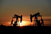 FILE PHOTO: Pump jacks operate at sunset in an oil field in Midland, Texas U.S. August 22, 2018. REUTERS/Nick Oxford/File Photo