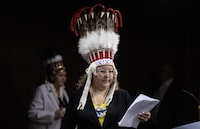National Chief of the Assembly of First Nations Cindy Woodhouse Nepinak places her papers on the podium at the start of a news conference on Parliament Hill, Wednesday, April 17, 2024 in Ottawa. The minister of Crown-Indigenous relations is calling on Air Canada to "make things right" with the national chief of the Assembly of First Nations whose headdress was removed from a flight's cabin. THE CANADIAN PRESS/Adrian Wyld