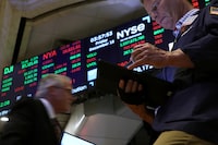 Traders work on the floor at the New York Stock Exchange (NYSE) on Dec. 15.