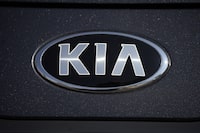 FILE - The company logo shines off the hood of a 2021 K5 sedan on display in the Kia exhibit at the Denver auto show Friday, Sept. 17, 2021, at Elitch's Gardens in downtown Denver. Kia is recalling about 320,000 cars in the U.S. to fix a problem that could stop the trunk from being opened from the inside, Thursday, Aug. 31, 2023. The recall covers the Optima midsize car from 2016 through 2018, Optima hybrids and plug-ins from 2017 and 2018, and the Rio small car from 2016 and 2017. (AP Photo/David Zalubowski, File)