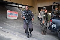 Police members take position during a police operation at the Salgueiro Complex, in Sao Goncalo, Rio de Janeiro state, Brazil, on March 23, 2023. - A police operation left at least 11 people dead in a favela near Rio de Janeiro, including the leader of a criminal gang operating in northern Brazil, local media reported, though the civil police did not confirm the death toll and reported a "still ongoing" operation. (Photo by CARL DE SOUZA / AFP) (Photo by CARL DE SOUZA/AFP via Getty Images)