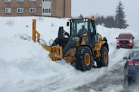 Crews clean up after a winter storm in Sydney, N.S. on Monday, Feb.5, 2024. A man in rural corner of Nova Scotia that has been digging out from under a massive snowfall has been accused of threatening a snowplow driver.THE CANADIAN PRESS/Shane Wilkie