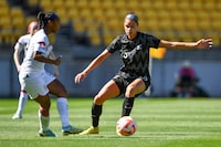 Crystal Dunn of the U.S., left, and Grace Jale of New Zealand compete for the ball during their women's international soccer friendly game in Wellington, New Zealand, Wednesday, Jan. 18, 2023. (Mark Tantrum/Photosport via AP)