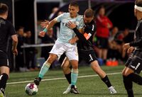 Pacific FC's Manny Aparicio, left, protects the ball from TSS Rovers' Matteo Polisi during second half Canadian Championship quarterfinal soccer action in Langford, B.C., on Wednesday, May 10, 2023. THE CANADIAN PRESS/Chad Hipolito
