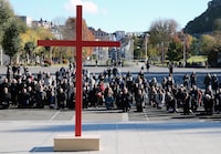 FILE - Bishops kneel on the forecourt of the Notre-Dame-du-Rosaire basilica in the sanctuary of Lourdes, southwestern France, Saturday, Nov. 6, 2021. More than 500 victims of child sexual abuse by priests or other church representatives have received financial compensation from France's Catholic Church under a sweeping reparations program, the independent body in charge of the process said Thursday March 14, 2024. (AP Photo/Bob Edme, File)