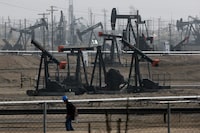 FILE - Pumpjacks operating at the Kern River Oil Field are seen in Bakersfield, Calif., on Jan. 16, 2015. The state of California has filed a lawsuit against some of the world's largest oil and gas companies, claiming they deceived the public about the risks of fossil fuels blamed for climate change-related storms and wildfires that caused billions of dollars in damage. (AP Photo/Jae C. Hong, File)