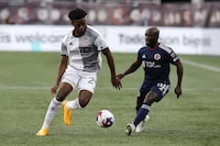 New England Revolution's Ema Boateng (18) defends against Toronto FC's Deandre Kerr (29) during the first half of an MLS soccer match Saturday, June 24, 2023, in Foxborough, Mass. (AP Photo/Michael Dwyer)