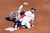 Toronto Blue Jays' Alejandro Kirk reacts as he tagged out at second base by Boston Red Sox shortstop Trevor Story after trying to stretch a single into a double during fifth inning American League MLB baseball action in Toronto on Saturday, September 16, 2023. THE CANADIAN PRESS/Chris Young