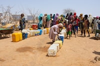 Sudanese refugees gather to get water from a water point in the Farchana refugee camp, on April 8, 2024. Chad is home to the largest number of Sudanese refugees, nearly a million. In a year since the conflict in Sudan started between two rival factions of the military government, more than 571,000 have rushed there on foot or by mule, adding to more than 400,000 compatriots who fled the previous Darfur war since 2003. (Photo by Joris Bolomey / AFP) (Photo by JORIS BOLOMEY/AFP via Getty Images)