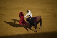 Spanish bullfighter Manuel Escribano performs a pass on a bull using a muleta during the Feria de Abril bullfighting festival at La Maestranza bullring in Seville on April 21, 2024. (Photo by CRISTINA QUICLER / AFP) (Photo by CRISTINA QUICLER/AFP via Getty Images)