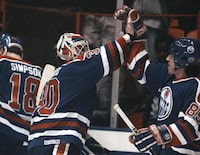 FILE - Edmonton Oilers' goalie Bill Ranford, center, and Petr Klima (85), right, celebrate their overtime win to sweep the NHL playoff series against the Los Angeles Kings at the Forum in Inglewood, Calif., Tuesday, April 25, 1990. Czech forward Petr Klima, a Stanley Cup winner with the Edmonton Oilers in 1990, has died. He was 58. Klima died Thursday, May 4, 2023, in the Czech Republic. The cause of death was not given. (AP Photo/Bob Galbraith, File)