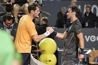 Britain's Andy Murray, left, and Italy's Fabio Fogini shake hands after their match during the Rome Masters tennis tournament in Rome, Italy, Wednesday, May 10, 2023. Fogini defeated Murray by 6-4, 4-6, 6-4. (Fabrizio Corradetti/LaPresse via AP)