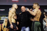 Sean Strickland, left, and Dricus Du Plessis face off during weighs in ahead of his UFC Middleweight title bout in Toronto, Friday, Jan. 19, 2024.   THE CANADIAN PRESS/Cole Burston