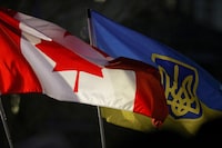 FILE PHOTO: A Canadian flag and a Ukrainian flag with the tryzub are seen during a rally to mark the one year anniversary of Russia’s invasion of Ukraine at the Canadian Museum for Human Rights in Winnipeg, Manitoba, Canada on February 24, 2023.  REUTERS/Shannon VanRaes